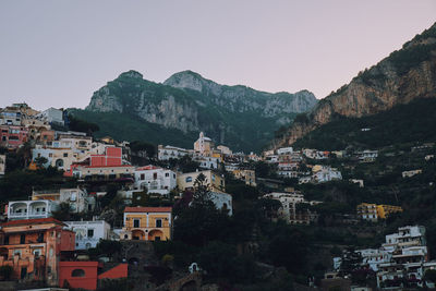 Buildings in town against clear sky