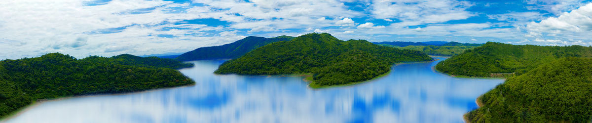 Scenic view of waterfall against sky