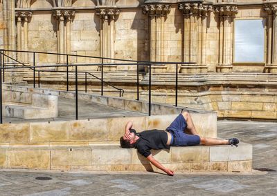 Man laying on stone steps at york minster