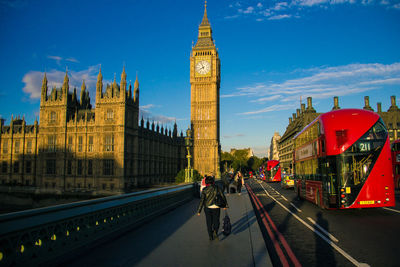 Panoramic view of people walking in city against sky