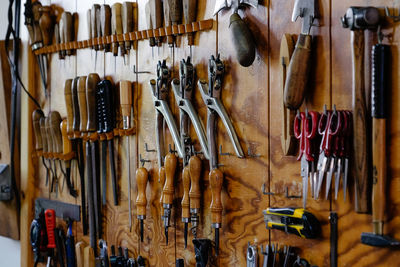 Hand tools on wooden wall at workshop