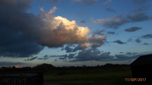 Scenic view of field against sky at sunset