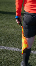 Low section of man standing on soccer field