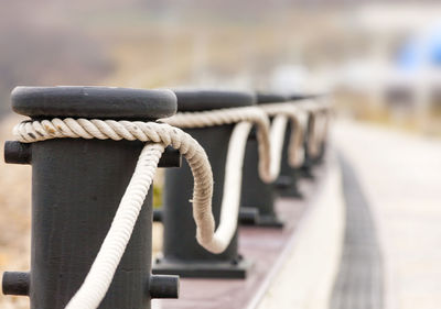 Bollards with ropes on a quay for decorative fencing