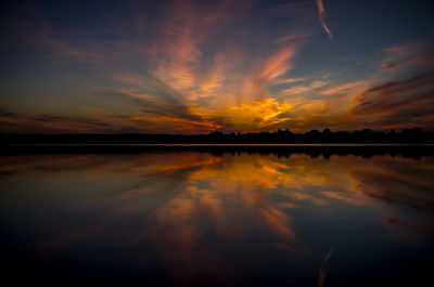 Scenic view of lake against romantic sky at sunset