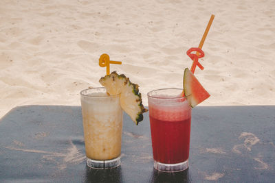 Close-up of drink on table at beach