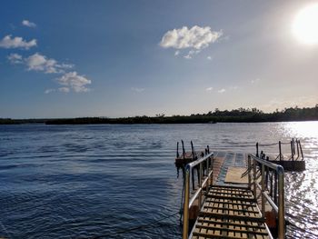 Pier over lake against sky
