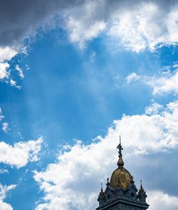 Low angle view of cross and building against sky