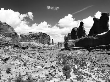 Abandoned building by rocks against sky