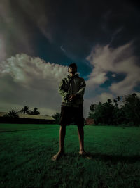 Man standing on field against sky