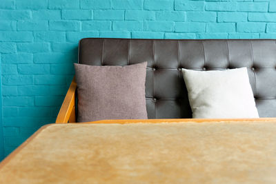 View of cushions on bed against wall