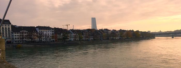 Scenic view of river against sky at sunset