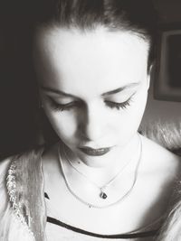 Close-up portrait of young woman with eyes closed