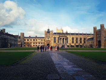 People in front of historical building in city