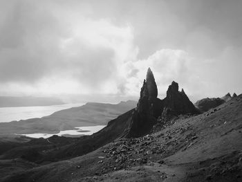 Scenic view of mountains against cloudy sky