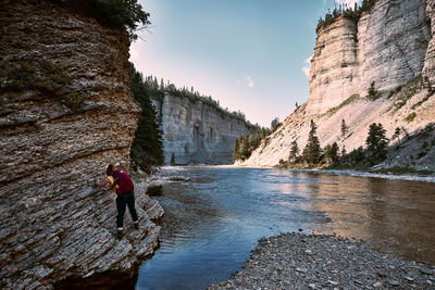 Hiking in canyon against a rock wall