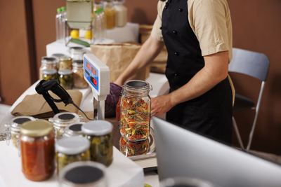 Midsection of man preparing food on table