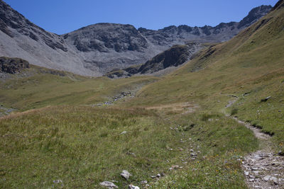 Scenic view of landscape and mountains against clear sky