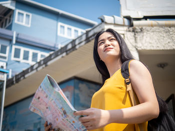 Low angle view of young woman looking at camera