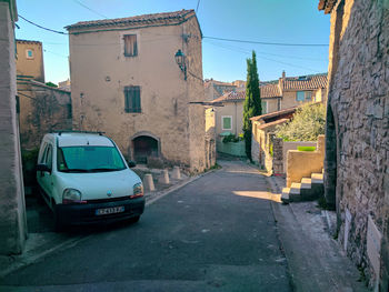 Car on street amidst buildings in city