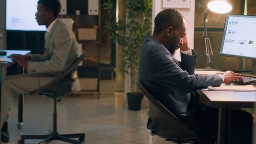 Rear view of man working in office