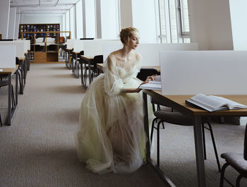 Charming ballerina went to the library to choose a new book showing your stretching and flexibility