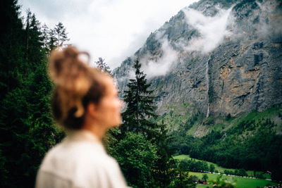 Woman looks at the mountains