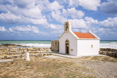 Building by sea against sky