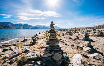 Stack of rocks on shore against sky