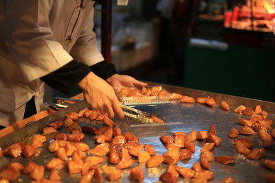 Midsection of man preparing food