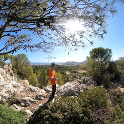Rear view of man standing on rock