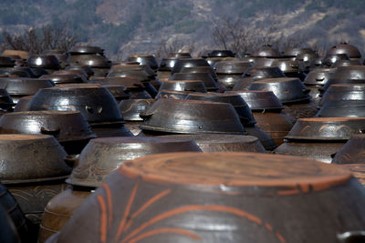 High angle view of big jars in row against mountain 