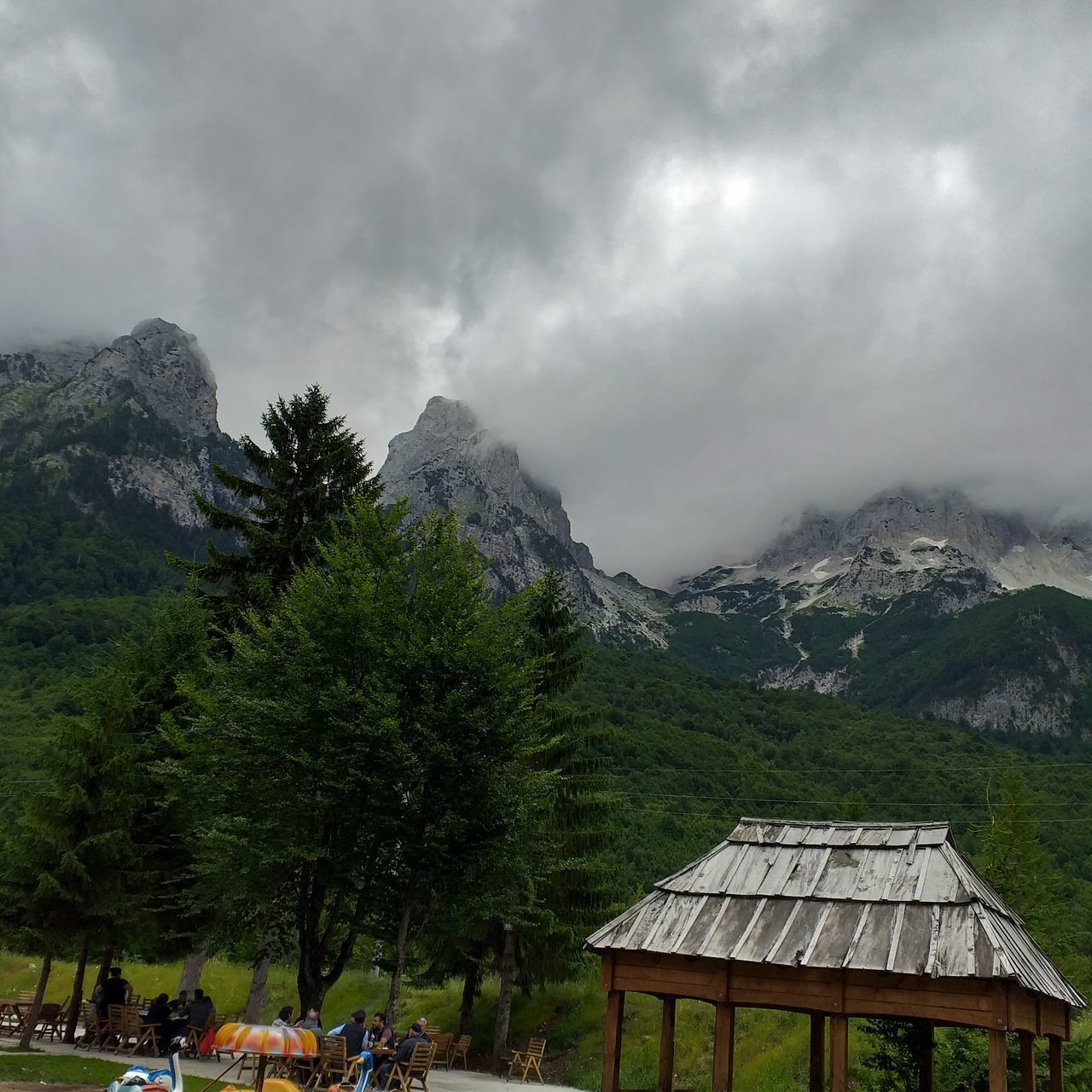 BUILT STRUCTURE AGAINST TREES AND MOUNTAINS