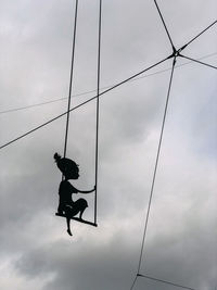 Low angle view of silhouette man against sky