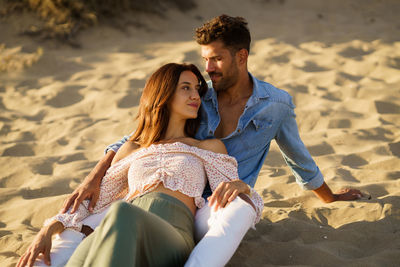 Young couple sitting on beach