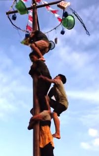 Low angle view of working hanging on rope against sky