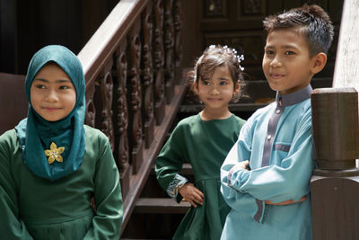 Portrait of siblings standing