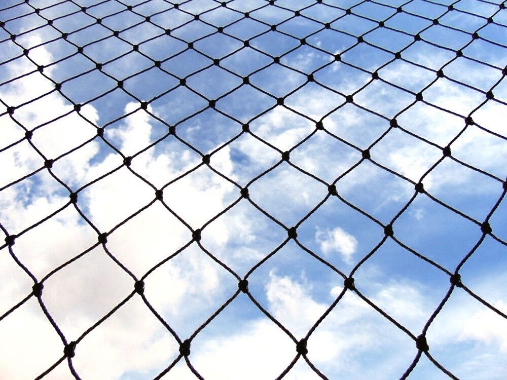 full frame, chainlink fence, cloud - sky, sky, backgrounds, fence, safety, protection, pattern, cloudy, security, metal, day, low angle view, cloud, blue, outdoors, no people, city, built structure