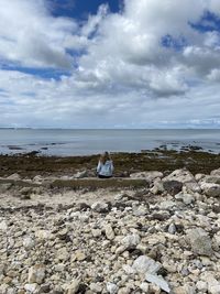 Scenic view of rocks on beach against sky