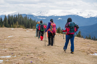 Rear view of people walking on mountain