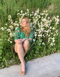 Young woman sitting on field