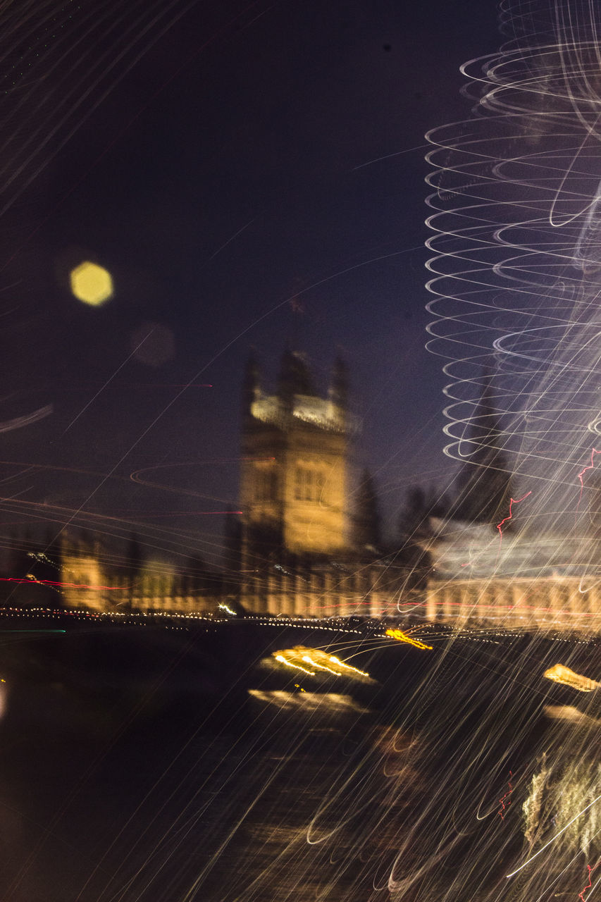 DIGITAL COMPOSITE IMAGE OF ILLUMINATED CITYSCAPE AGAINST SKY