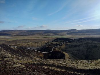 High angle view of road by land against sky