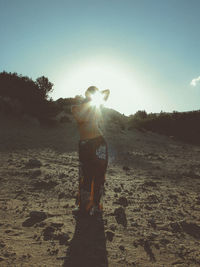 Rear view of silhouette man standing against clear sky