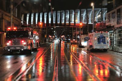 Vehicles on road in city at night