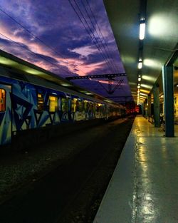 Empty railway station platform at night