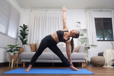 Young woman exercising in gym