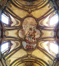 Low angle view of ornate ceiling in temple