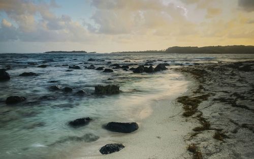 Scenic view of sea against cloudy sky