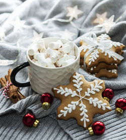 Christmas decorations, cocoa and gingerbread cookies. white wooden background.